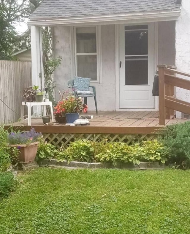 doorway to property featuring a yard and a deck