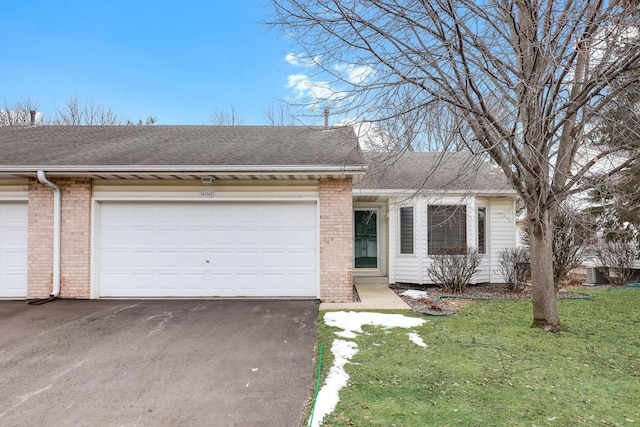 single story home with a garage and a front yard