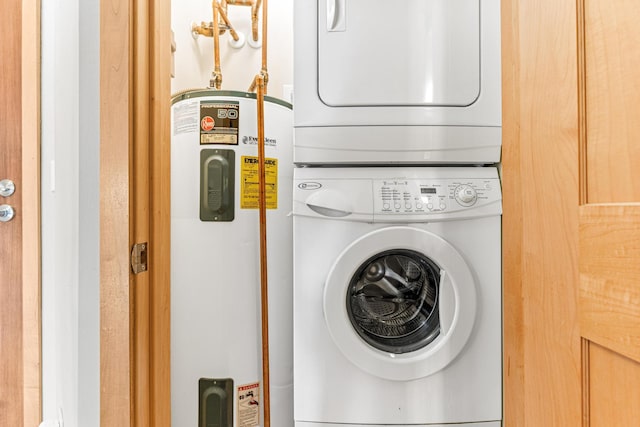 laundry room featuring stacked washer / drying machine and electric water heater