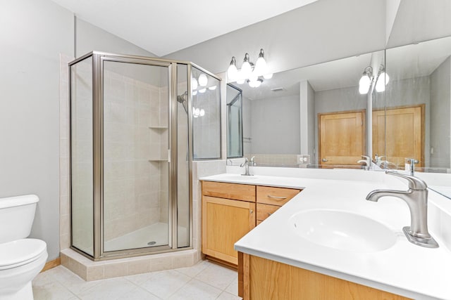 bathroom with tile patterned flooring, vanity, toilet, and an enclosed shower