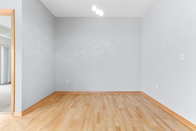 spare room featuring light wood-type flooring