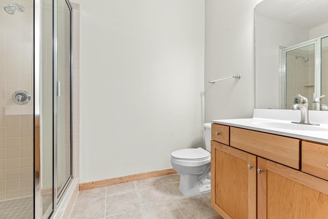 bathroom featuring tile patterned floors, vanity, toilet, and an enclosed shower