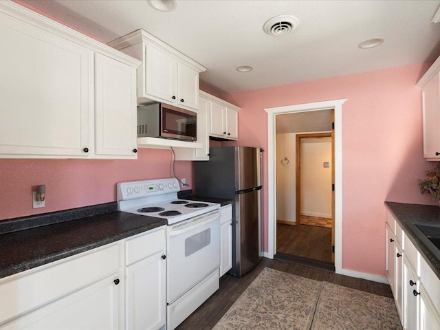 kitchen featuring dark hardwood / wood-style flooring, white electric stove, and white cabinets