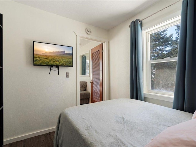 bedroom featuring dark hardwood / wood-style flooring