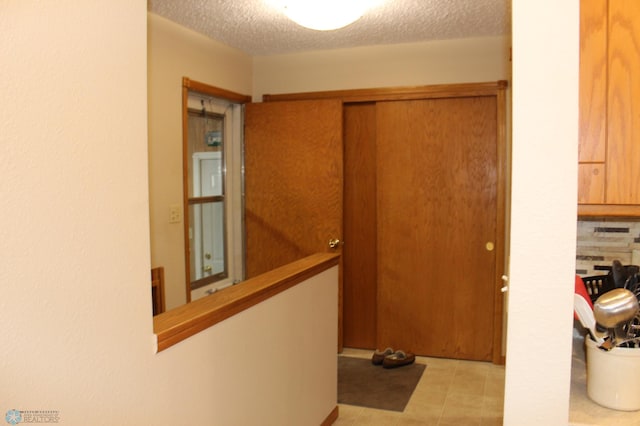 hallway with a textured ceiling