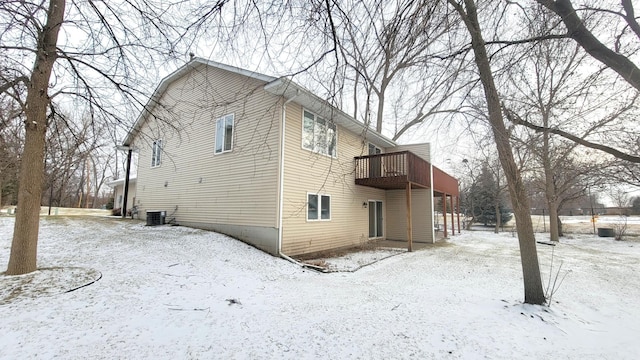 view of snow covered exterior featuring cooling unit