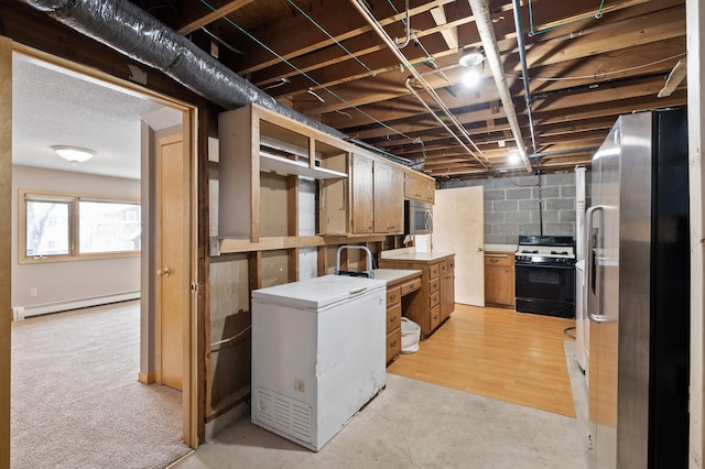 basement featuring a baseboard heating unit, refrigerator, and stainless steel fridge with ice dispenser