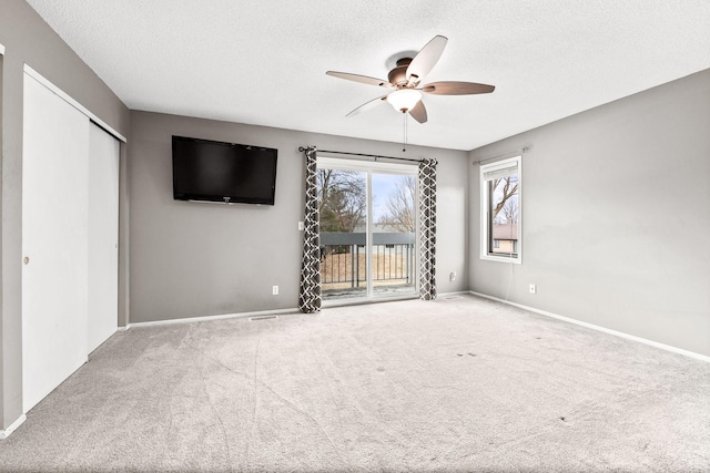 interior space with ceiling fan and a textured ceiling