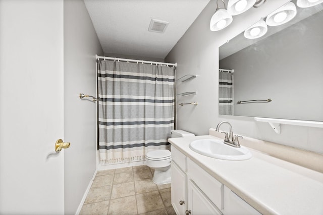 bathroom with vanity, toilet, and tile patterned flooring