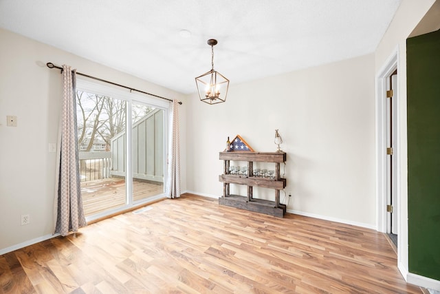 interior space featuring a chandelier and light hardwood / wood-style flooring