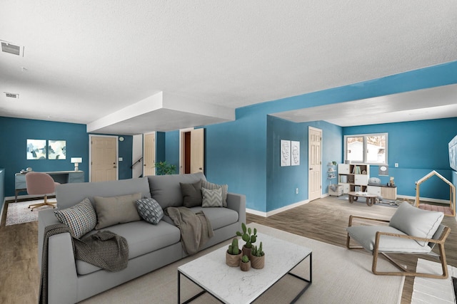 living room featuring hardwood / wood-style floors and a textured ceiling