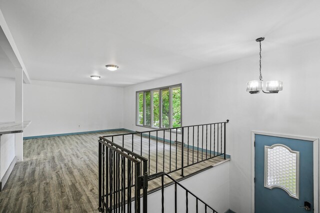 1813 Stinson Blvd, New Brighton, MN 55112 - stairway featuring wood finished floors, a chandelier, and baseboards
