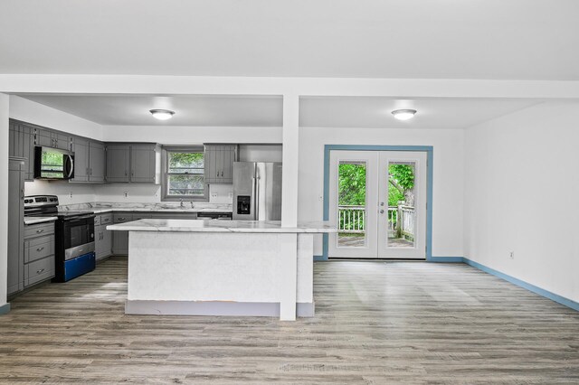 1813 Stinson Blvd, New Brighton, MN 55112 - kitchen featuring stainless steel appliances, gray cabinets, light wood-style flooring, and baseboards