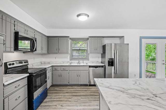 1813 Stinson Blvd, New Brighton, MN 55112 - kitchen with appliances with stainless steel finishes, gray cabinetry, a sink, and light wood-style floors