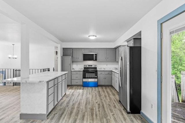 1813 Stinson Blvd, New Brighton, MN 55112 - kitchen featuring stainless steel appliances, gray cabinetry, light wood-style flooring, and a chandelier