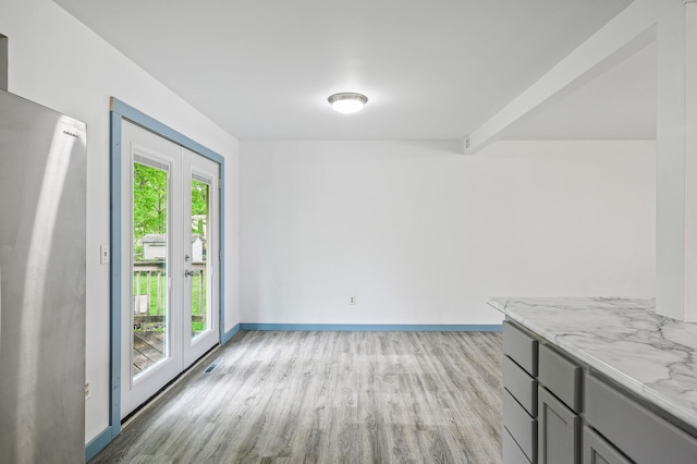 1813 Stinson Blvd, New Brighton, MN 55112 - unfurnished dining area with light wood-style floors and baseboards