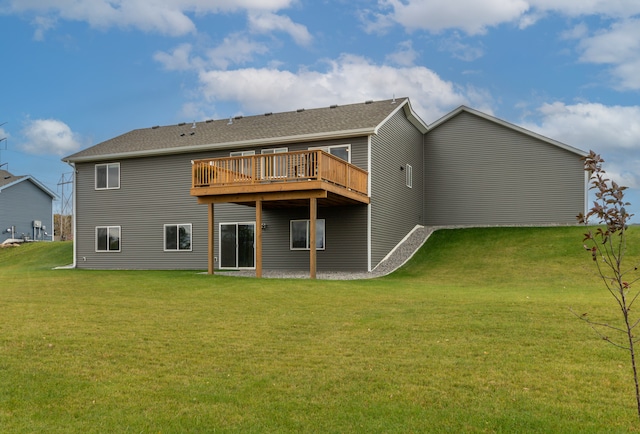 back of house featuring a wooden deck and a lawn