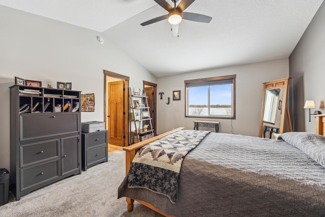 carpeted bedroom with ceiling fan and vaulted ceiling