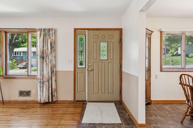 foyer entrance featuring baseboards and healthy amount of natural light