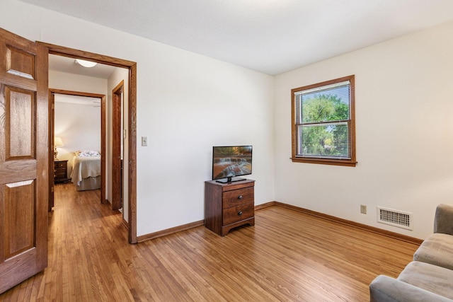 sitting room featuring light wood finished floors and baseboards