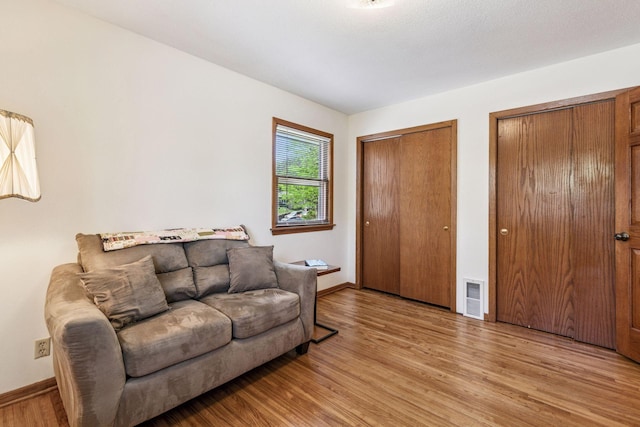 living room featuring light wood-style flooring and baseboards
