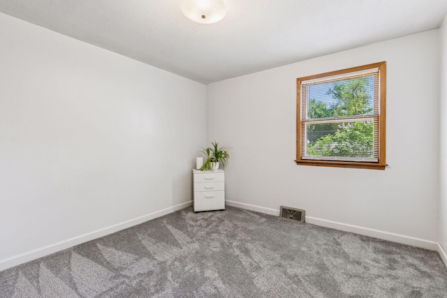 carpeted empty room with baseboards