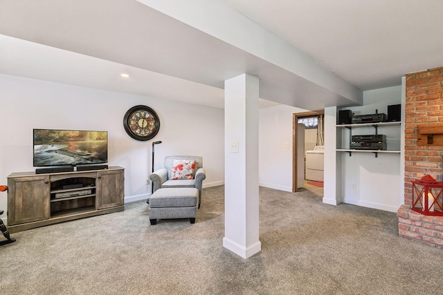living room featuring carpet floors, baseboards, and washer / dryer