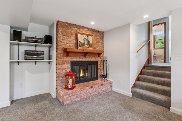 living room featuring carpet, stairs, a brick fireplace, baseboards, and recessed lighting