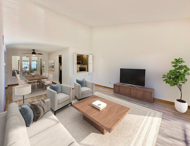 living room featuring ceiling fan and light wood-type flooring