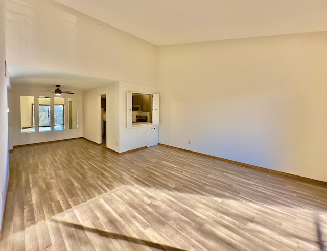 unfurnished living room with ceiling fan and lofted ceiling