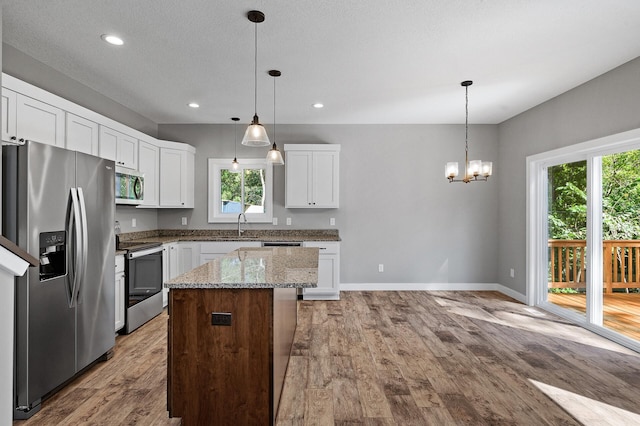 kitchen with white cabinetry, appliances with stainless steel finishes, and a center island