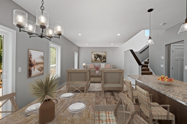 dining area with recessed lighting, plenty of natural light, stairway, and wood finished floors