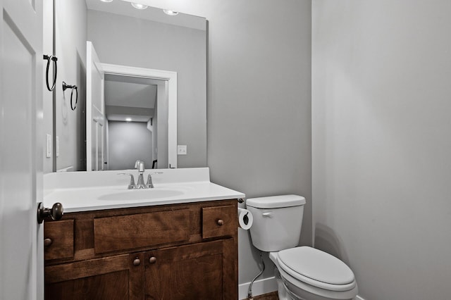 half bathroom featuring toilet and vanity