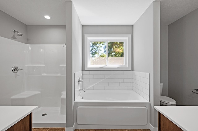 full bathroom with a shower, a garden tub, vanity, and toilet