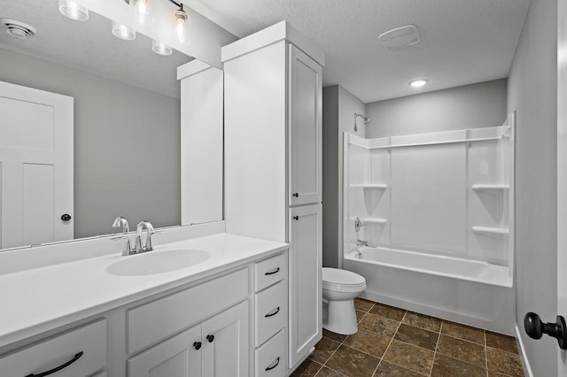 bathroom featuring a textured ceiling, toilet, vanity, visible vents, and  shower combination