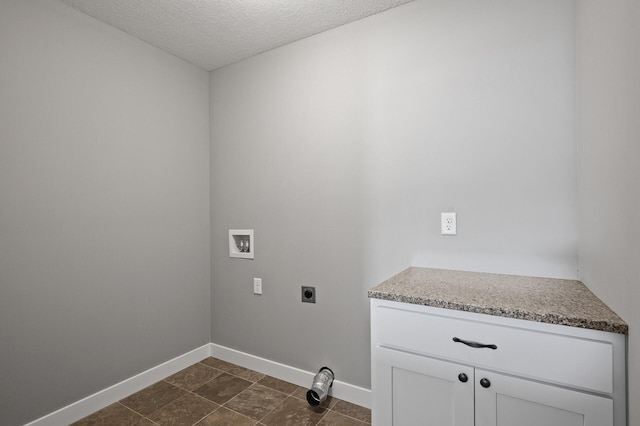 washroom featuring hookup for a washing machine, a textured ceiling, baseboards, and electric dryer hookup