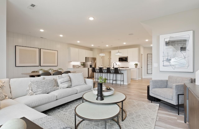 living room with light hardwood / wood-style flooring