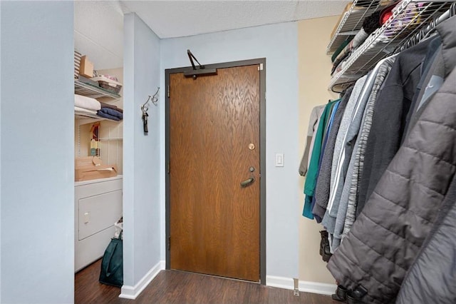 spacious closet featuring dark hardwood / wood-style flooring and washer / clothes dryer