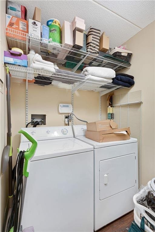 clothes washing area with washing machine and clothes dryer