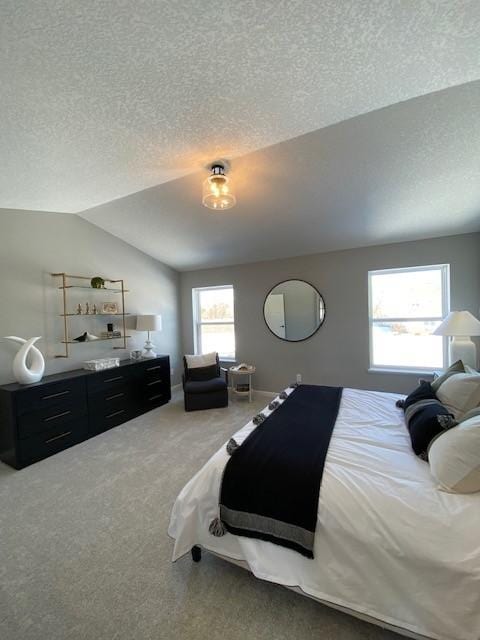 carpeted bedroom with a textured ceiling and lofted ceiling