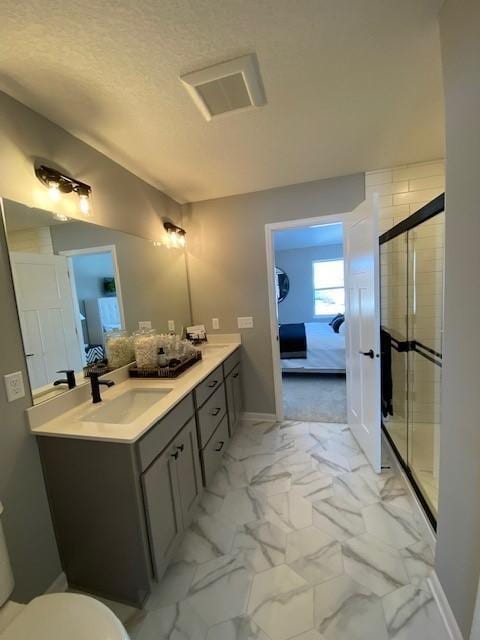 bathroom featuring toilet, vanity, and walk in shower