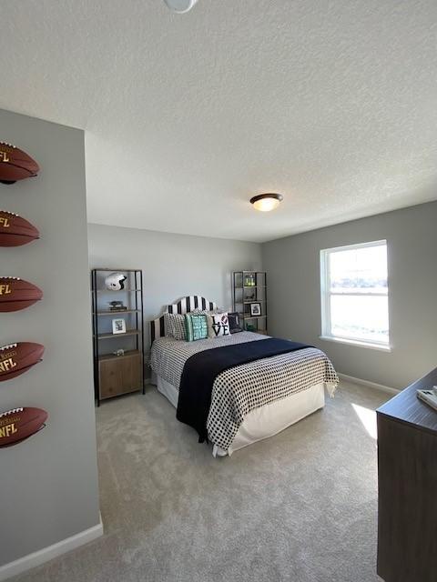 carpeted bedroom featuring a textured ceiling