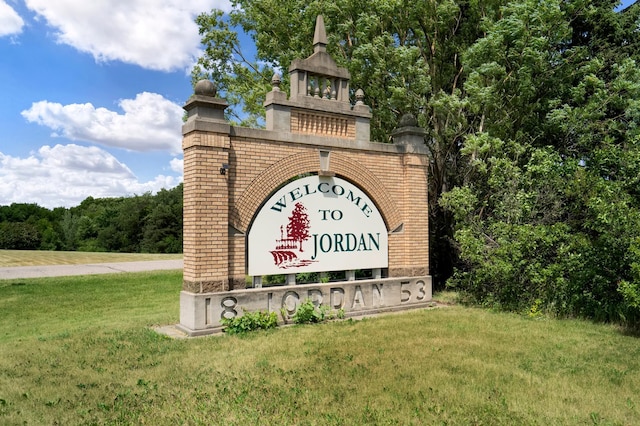 community / neighborhood sign with a lawn