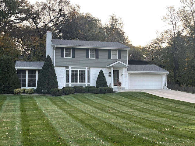 colonial-style house with a garage and a front yard