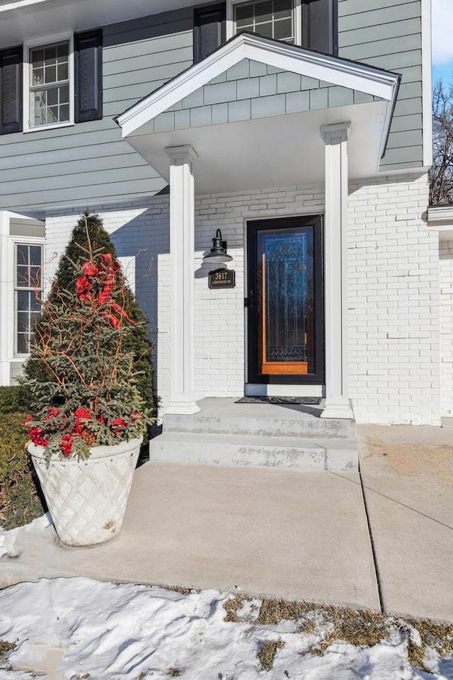 view of snow covered property entrance