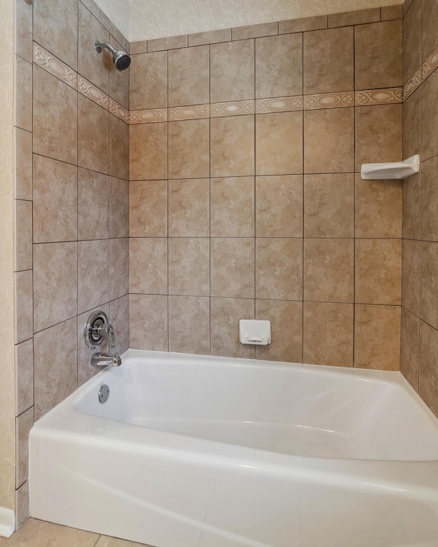 bathroom featuring tile patterned flooring and tiled shower / bath