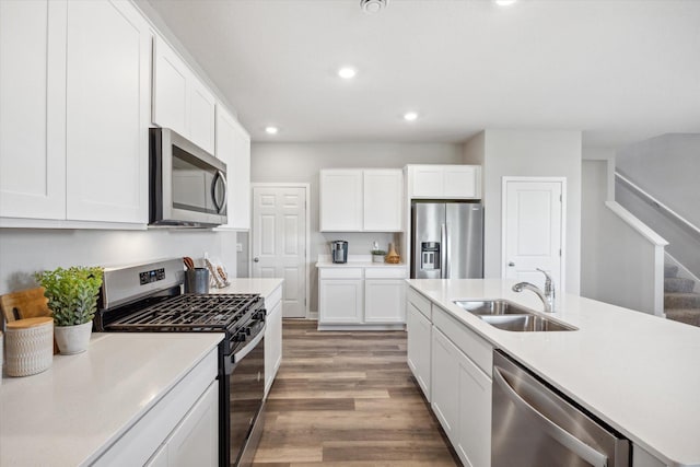 kitchen featuring dark wood-type flooring, sink, white cabinets, and stainless steel appliances