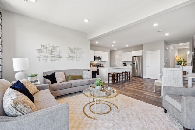 living room featuring recessed lighting and dark wood finished floors
