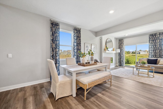 dining area with baseboards, recessed lighting, and wood finished floors