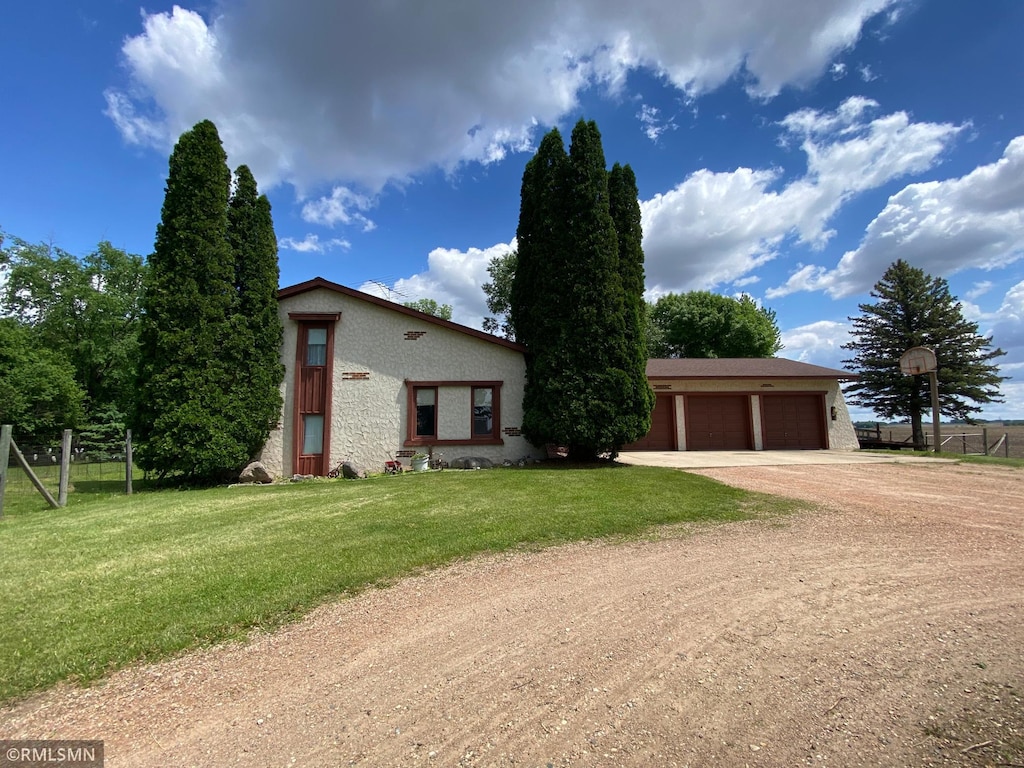 view of front of home with a front lawn and a garage